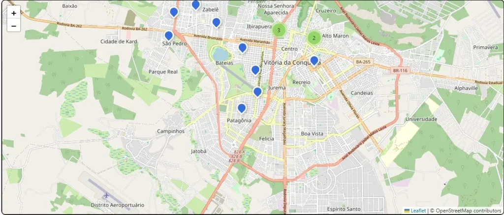 Mapa digital da área urbana do município de Vitória da Conquista, exibindo os nomes de diversos bairros sobre um plano de fundo em tons de verde, bege e branco, com vias em traçados laranjas e cinzas. No mapa, destacam-se vários pinos azuis de localização distribuídos por bairros como São Pedro, Bateias, Jurema, Recreio e Patagônia.